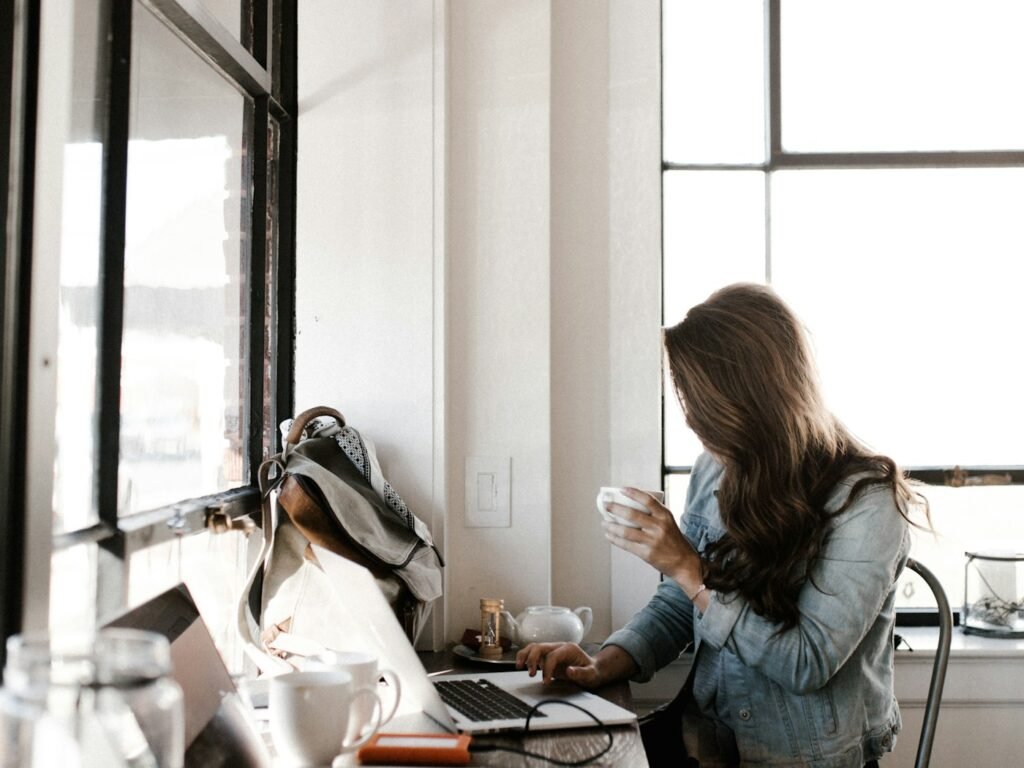 A founder working on a laptop with a coffee