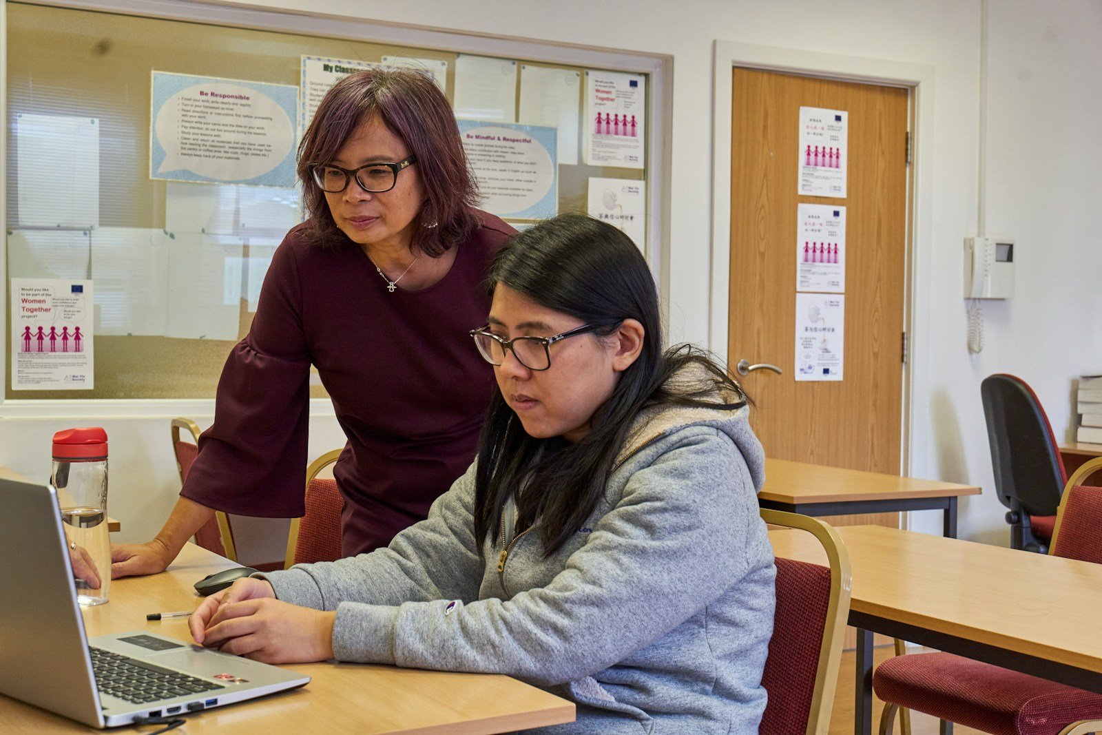 A mentor showing a founder something on a laptop
