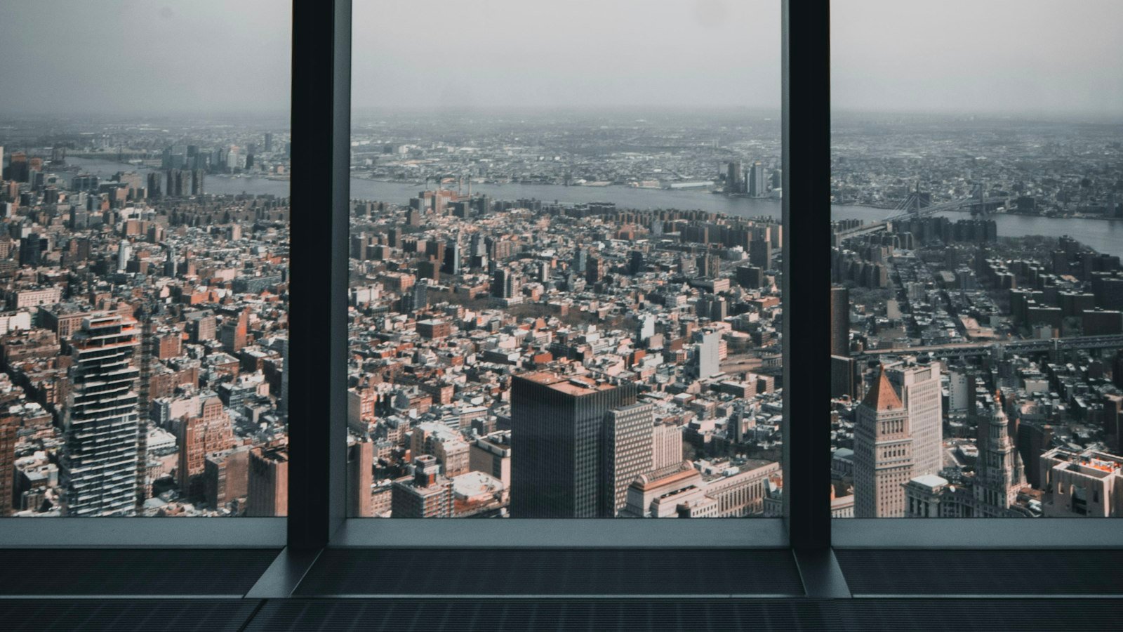 A wide city view from an office window while weighing the signs you should quit your job
