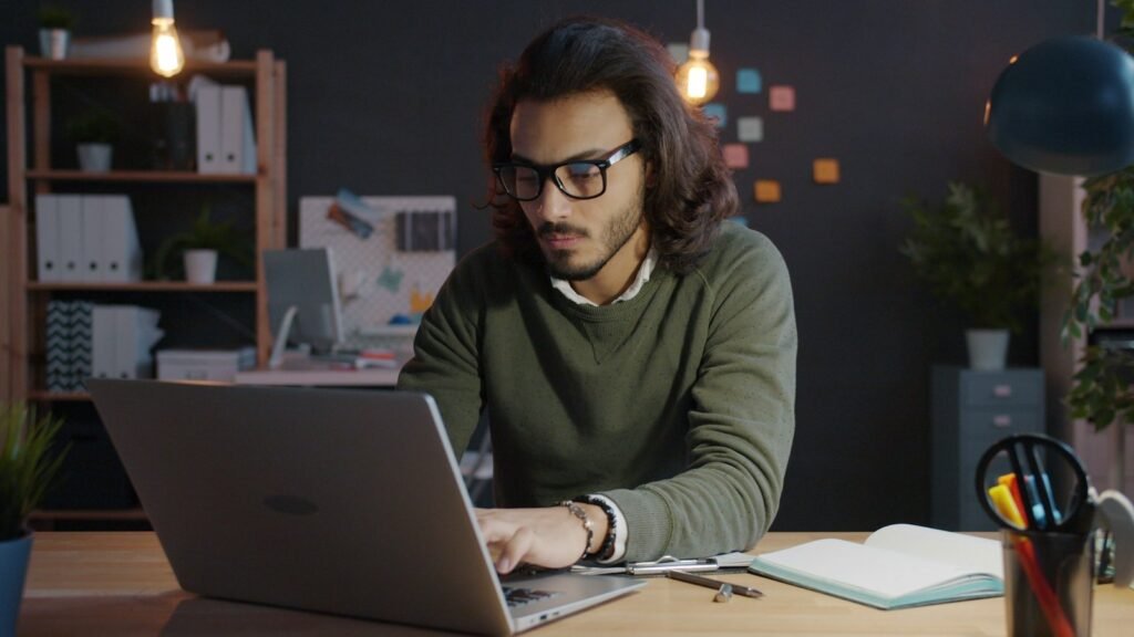 Working alone at a lit desk after hours to start a business while working full time