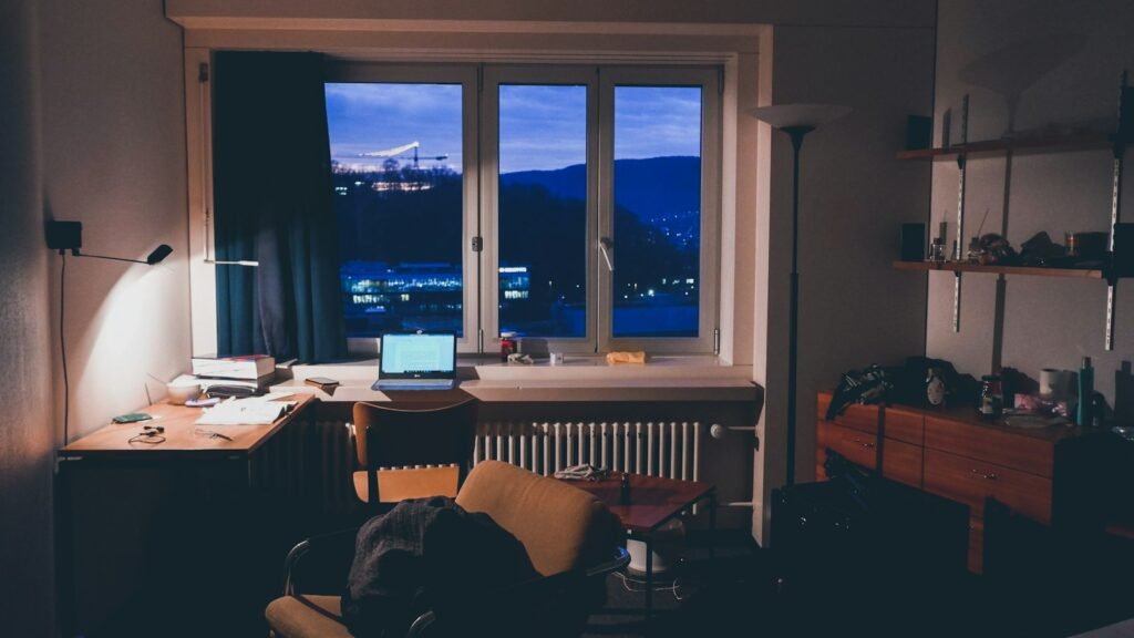 Desk with a laptop in a home office at night, the view a professional starting a business at 40 works from after hours