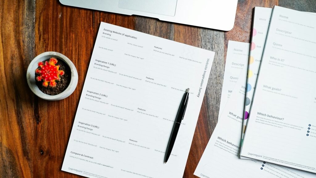 Papers and a pen on a wooden table, the paperwork behind a career change at 40