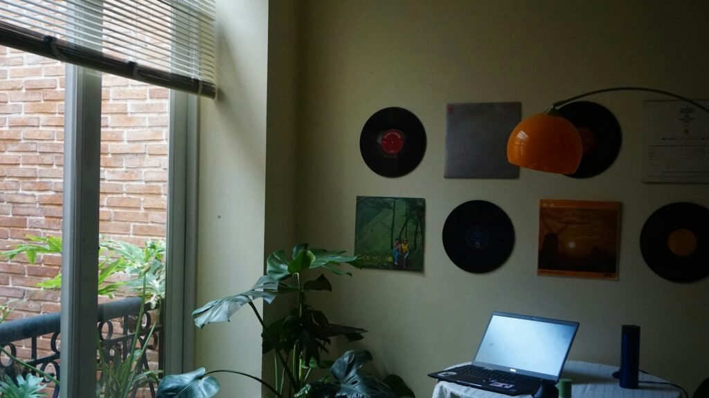 A laptop on a table in an apartment, the desk where you run the numbers before leaving a job to start a business